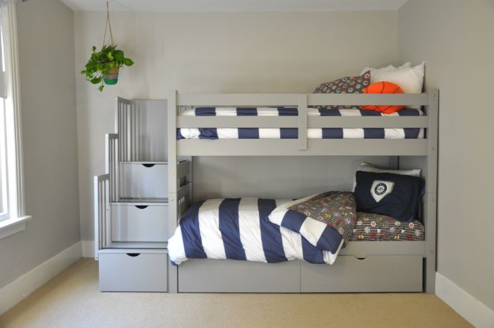 a bedroom with bunk beds and drawers in it