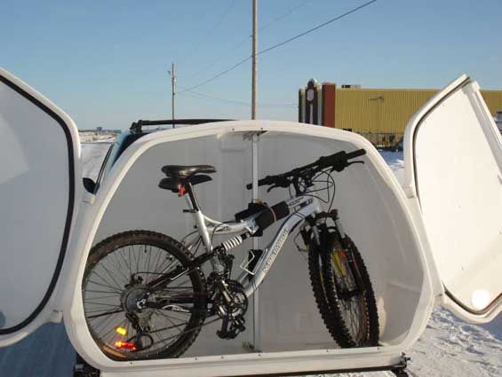 a bicycle is parked in the back of a trailer