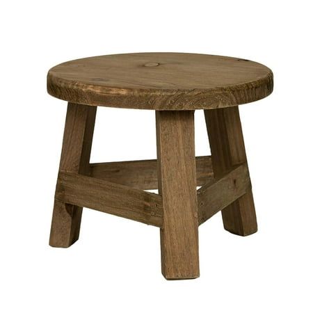 a small wooden stool sitting on top of a white background