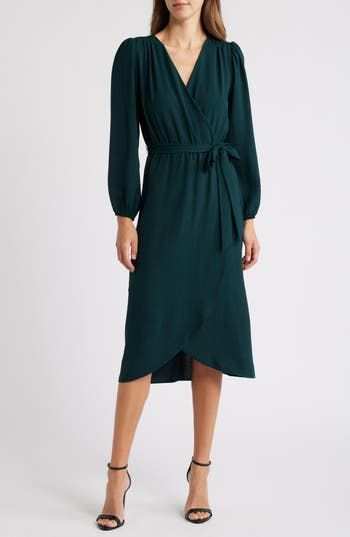 Show off contemporary style in this gracefully draped faux-wrap dress featuring puffed balloon sleeves and a removable tie belt. 48" length (size 8) Slips on over head Surplice V-neck Long sleeves with elastic cuffs Removable tie belt Unlined 100% polyester Machine wash, tumble dry Imported Model stats: 5'10" height, 32" bust, 25" waist, 36" hip. Model is wearing size 4. Dark Green Wrap Dress, Elegant Solid Color Wrap Dress For Work, Chic Draped Midi Dress For Fall, Chic Solid Wrap Dress For Formal Occasions, Chic Solid Color Wrap Dress For Formal Occasions, Chic Belted Midi Dress For Brunch, Chic Fall Midi Dress With Draped Sleeves, Elegant Midi Dress With Tie Fastening, Evening Long Sleeve Dress With Tie Waist