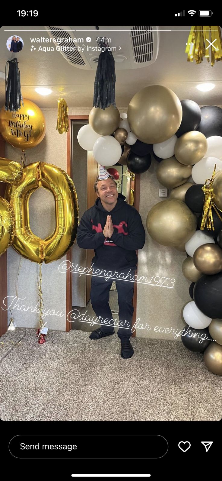 a man standing in front of balloons with the number 50 on it's side