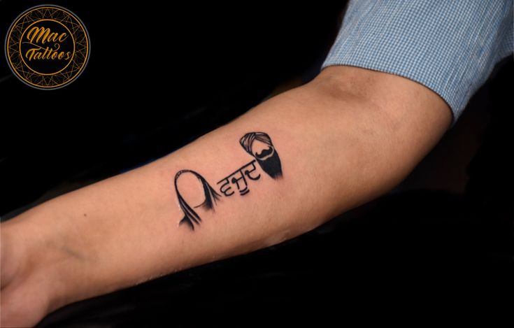 a person with a black and white tattoo on their arm