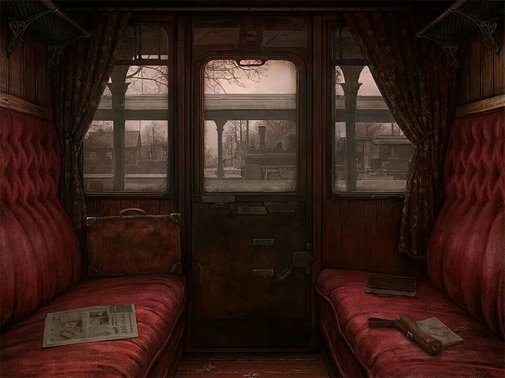 two red seats sitting next to each other in front of a door and window on a train