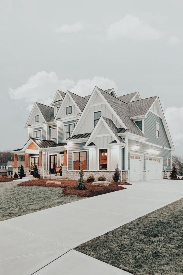 a large white and blue house with lots of windows