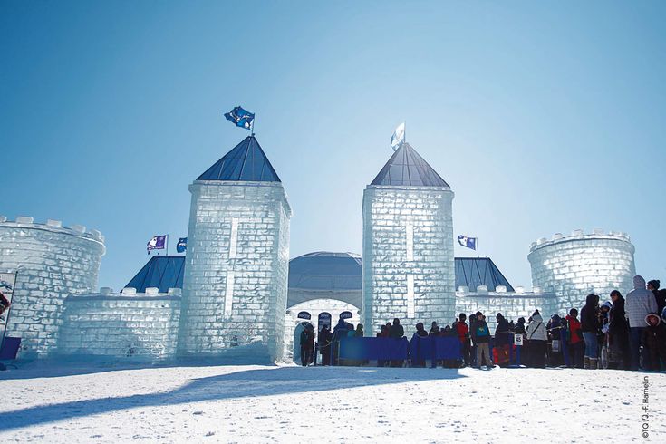 people are standing in front of an ice castle