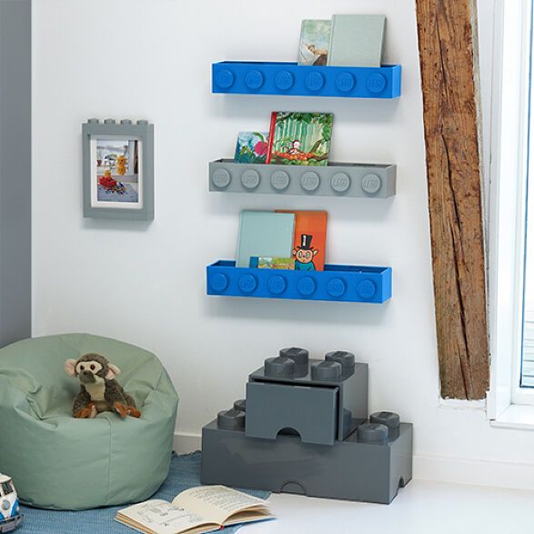 a child's room with legos and toys on the floor, including a bean bag chair