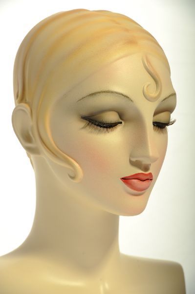 a white mannequin head with blonde hair