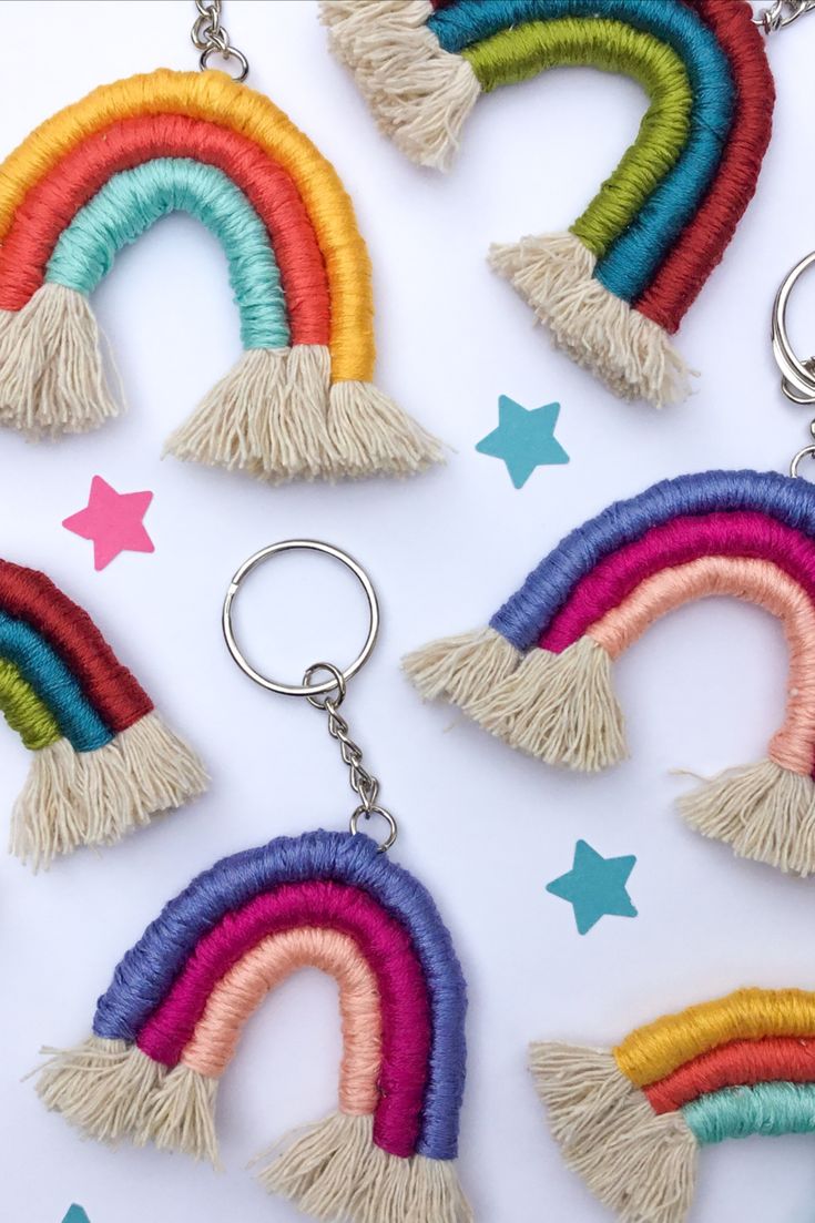 rainbow keychains with tassels and stars on the side, all in different colors