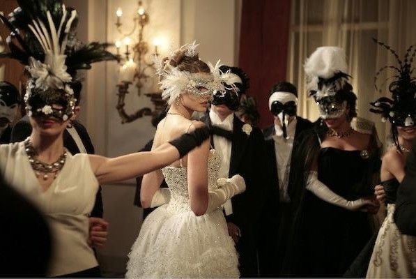 a group of people with masks on their faces and in dress up clothes standing around