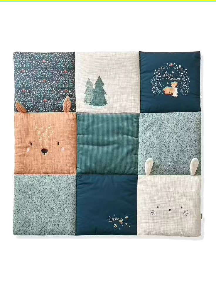 a quilted blanket with animals and trees on it