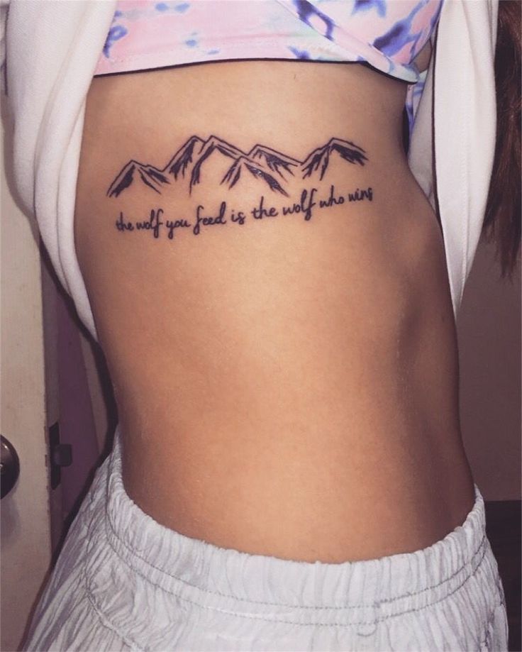 a woman's lower back tattoo with the words, what if you look at the mountains?