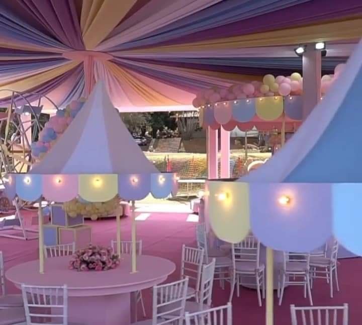 the inside of a tent with tables and chairs