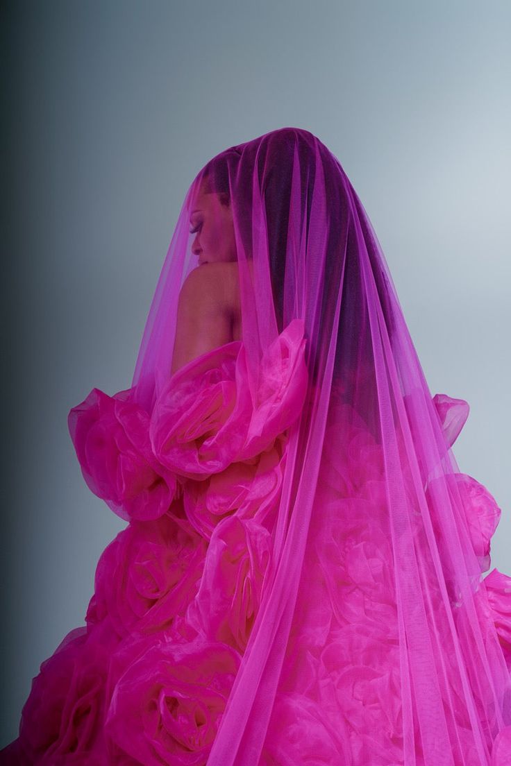 a woman wearing a pink dress and veil