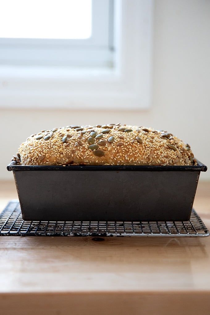 a loaf of bread sitting on top of a cooling rack in front of a window