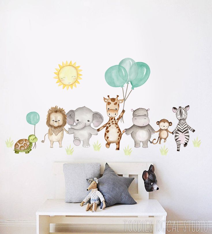 an animal themed wall decal in a child's room with balloons and giraffes