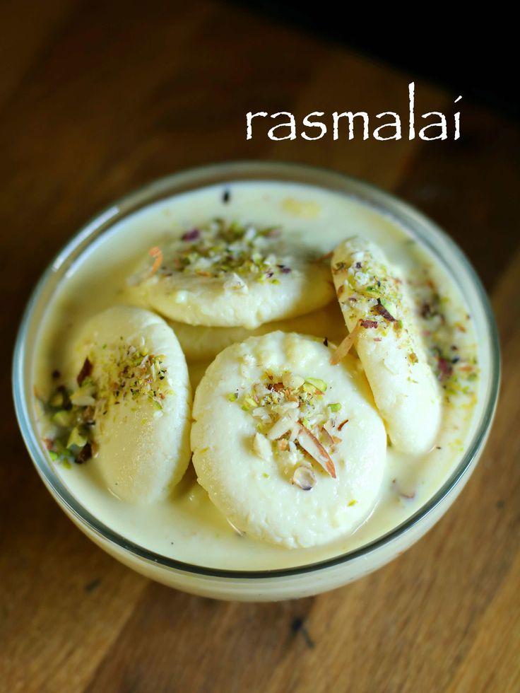 some food is in a glass bowl on a wooden table with the words rasmali above it