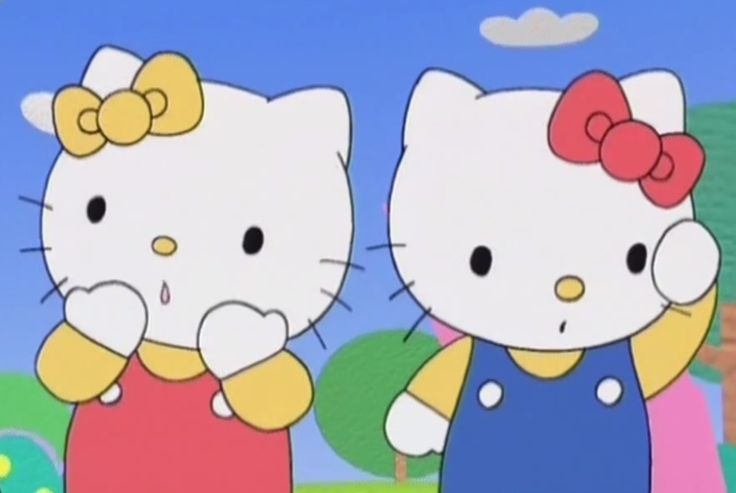 two hello kitty standing next to each other