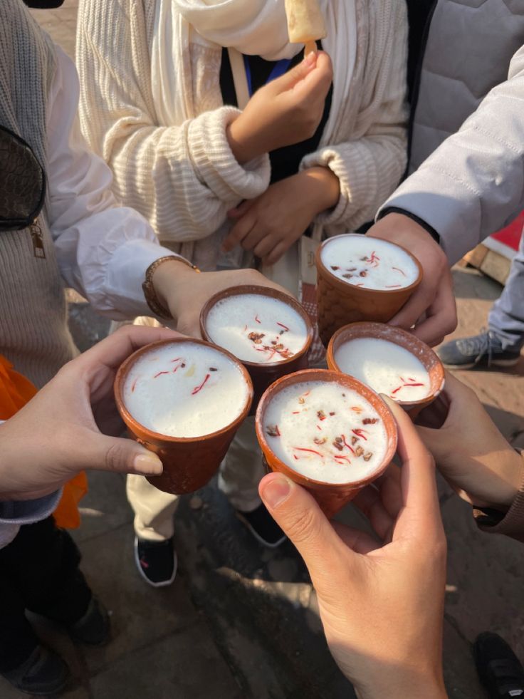 several people are holding their cups with blood on them