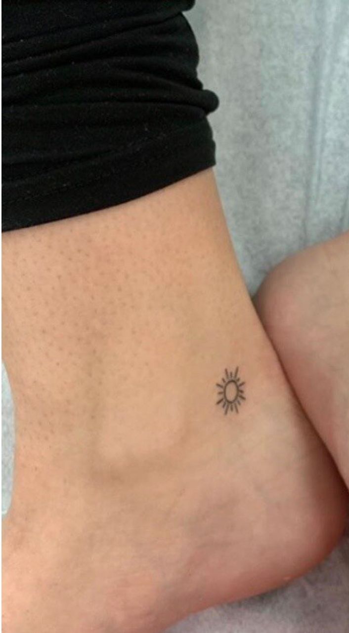 two small sun tattoos on the side of their legs, one is black and white