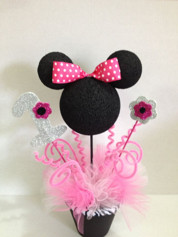 a minnie mouse head with pink and silver flowers in it's centerpieces