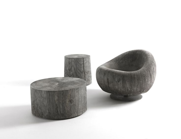 three wooden stools sitting next to each other on a white surface and one is shaped like a bird's nest