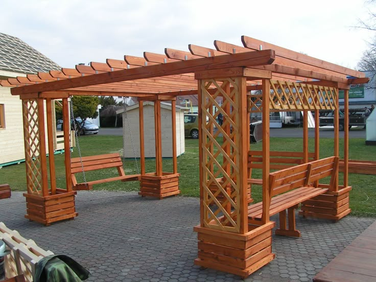 a wooden gazebo sitting on top of a brick patio