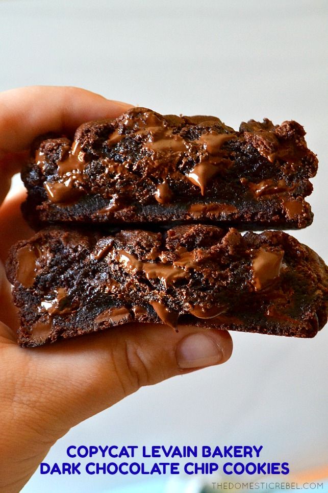 two chocolate brownies with caramel drizzled on top are being held in front of the camera