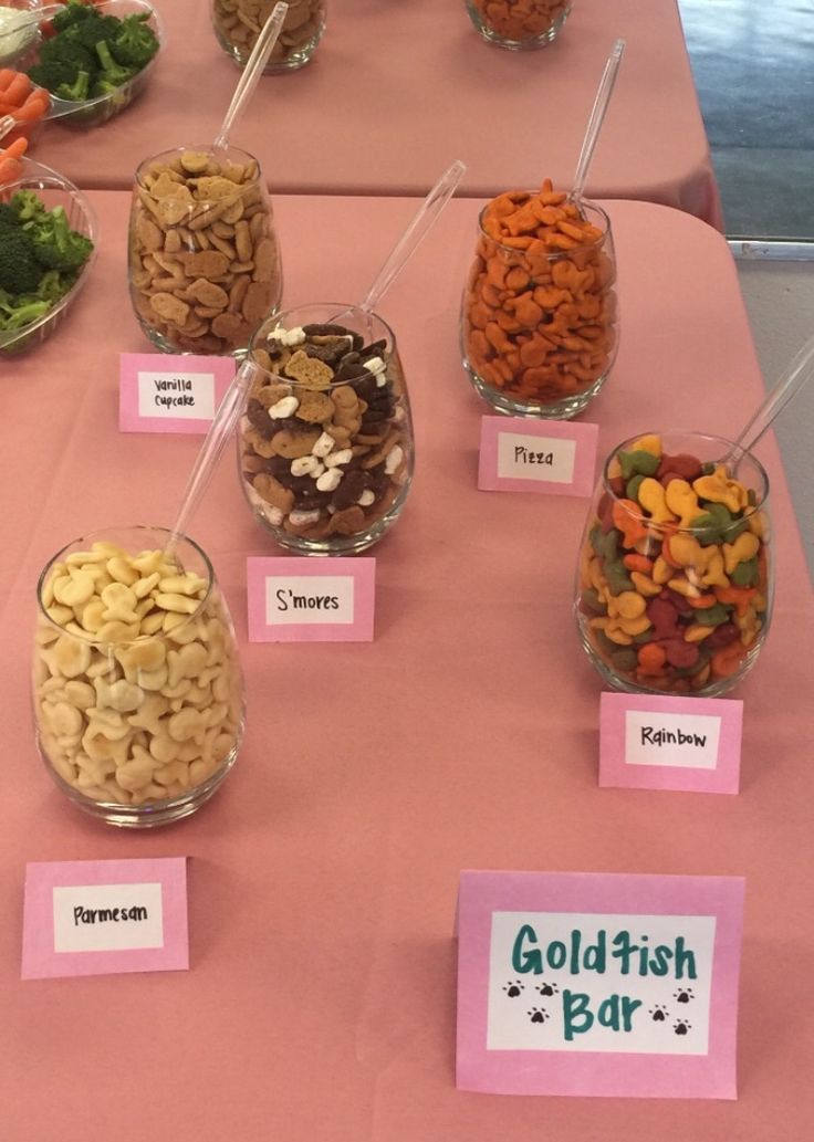 a table topped with lots of different types of foods and candy bars on top of it