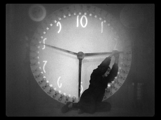 a black and white photo of a clock with the hands on it's face