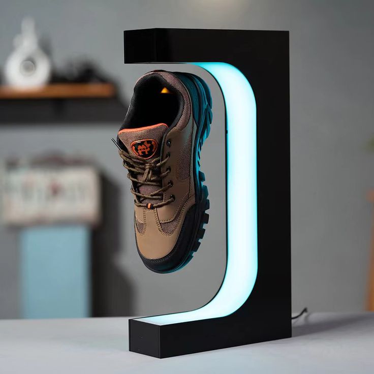 a pair of shoes hanging off the side of a black and blue light - up letter