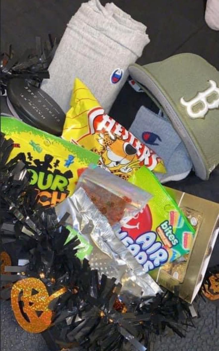 a pile of junk sitting on top of a floor next to a hat and other items