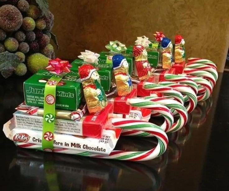 candy canes are lined up on top of each other and wrapped in holiday ribbon