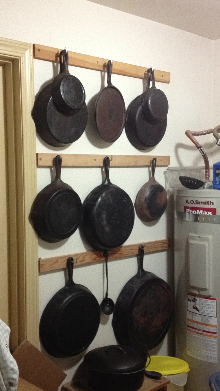 pots and pans are hanging on the wall