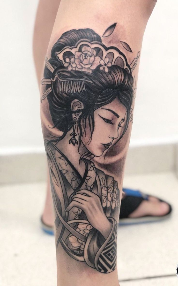 a woman with a geisha tattoo on her leg, holding a flower in her hair