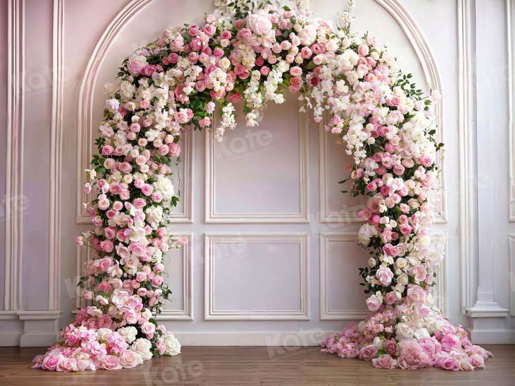 a floral arch with pink and white flowers