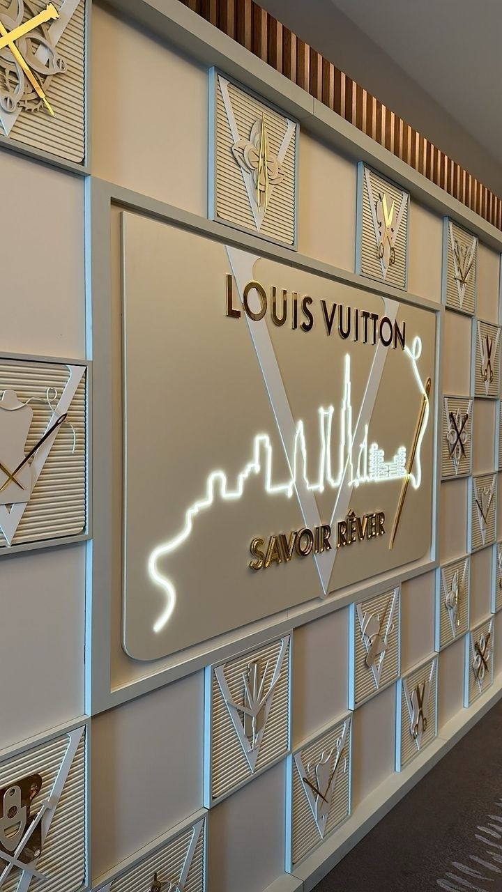 the louis vuitton savoir river sign is illuminated in gold and silver