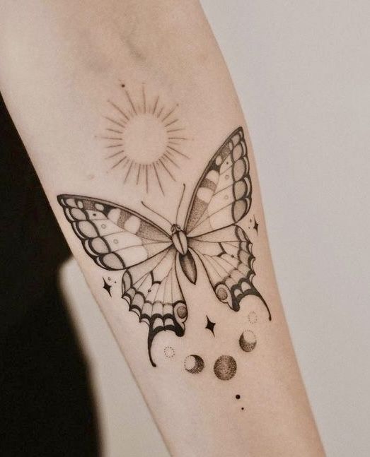 a woman's arm with a butterfly tattoo on the left side of her arm