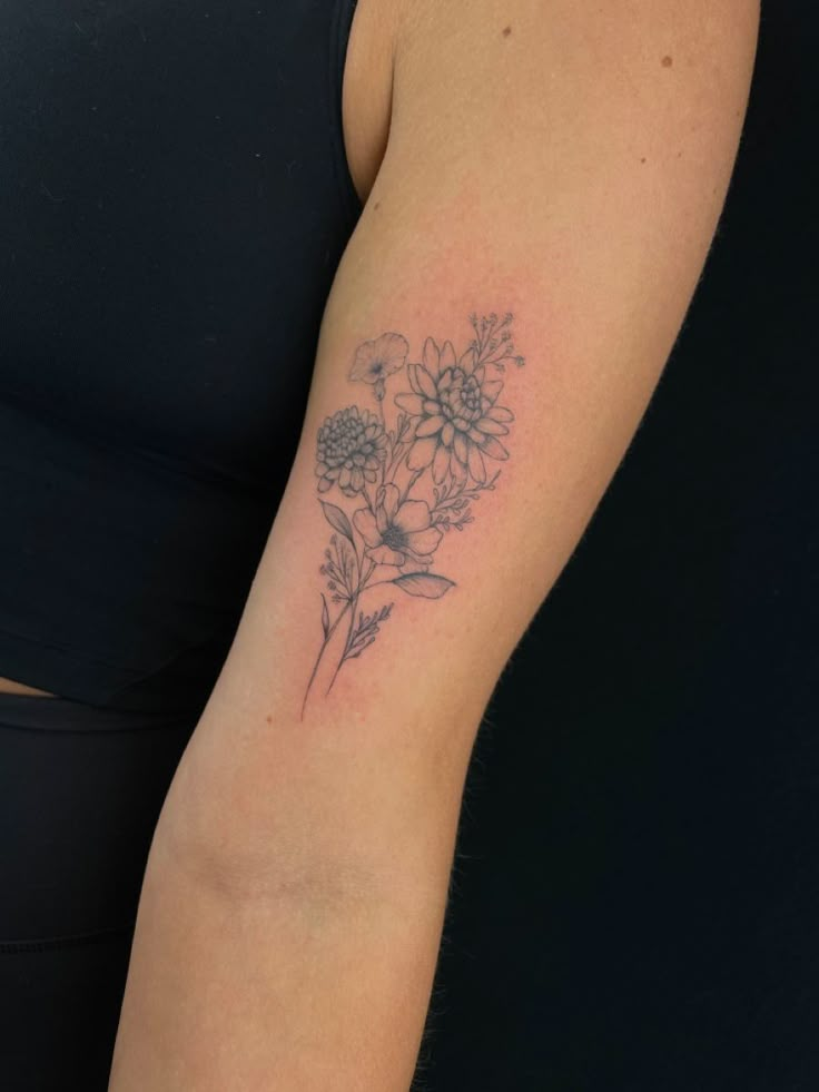 a woman with a flower tattoo on her arm