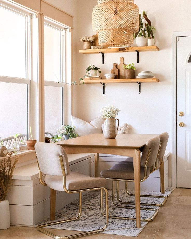 a dining room table with chairs and shelves above it