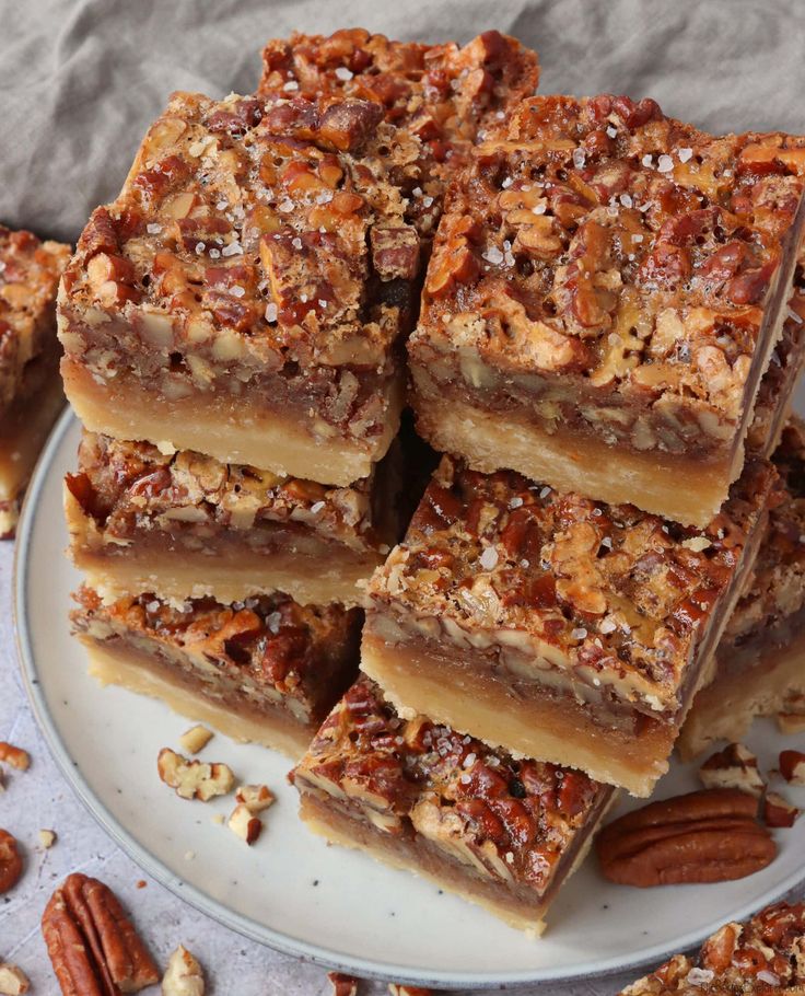 maple pecan pie bars stacked on top of each other