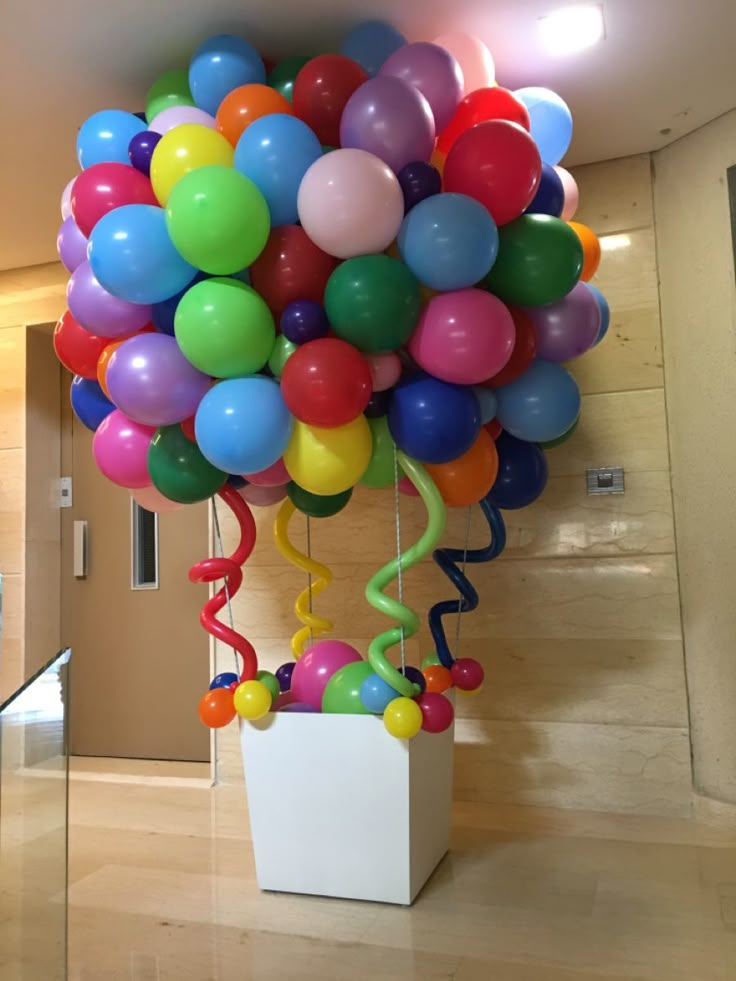 a bunch of balloons that are in a vase