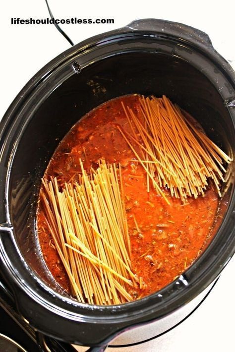 spaghetti being cooked in the slow cooker