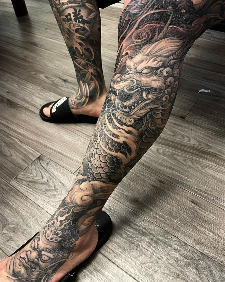 a person with tattoos on their legs and feet