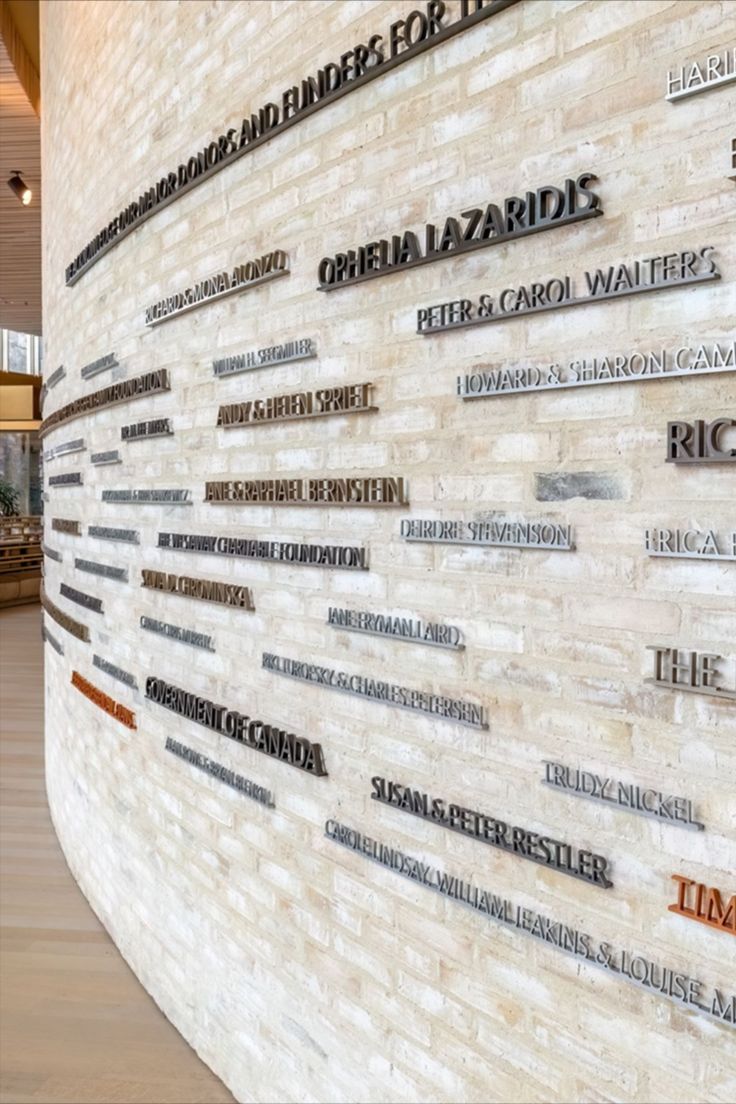 there are many names on the wall in this building that is made out of bricks