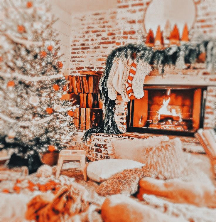 a living room filled with furniture and a fire place next to a christmas tree in front of a fireplace