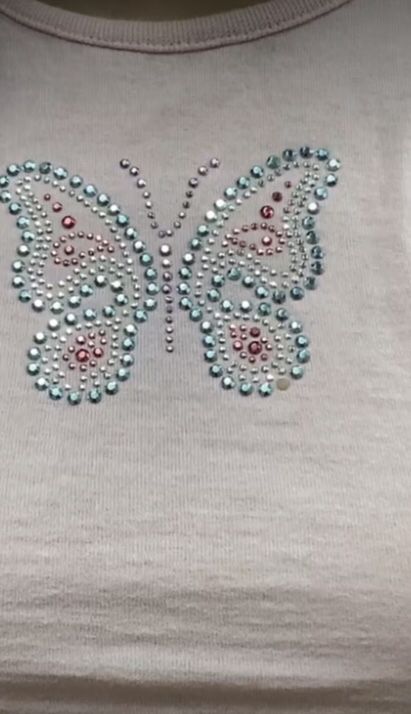 a t - shirt that has a butterfly on it