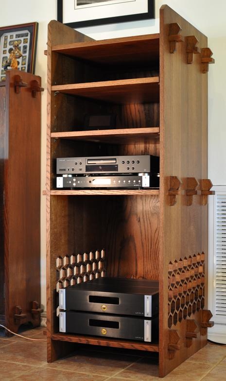 a wooden entertainment center with two stereos on top of it and an amplifier in front of it