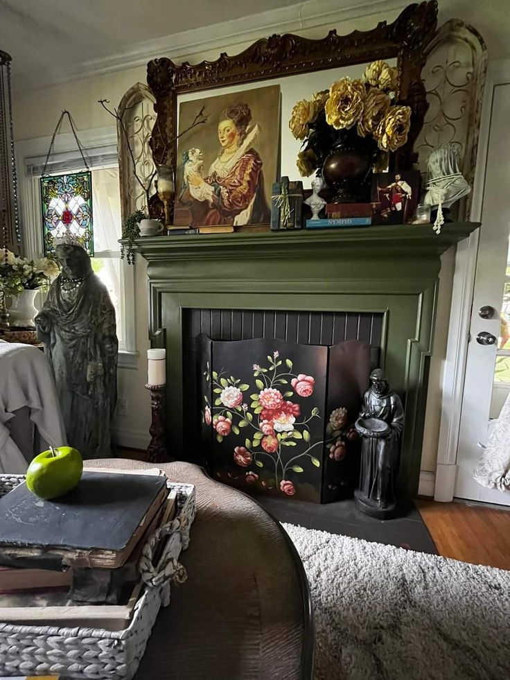 a living room filled with furniture and a fire place covered in art on the mantle