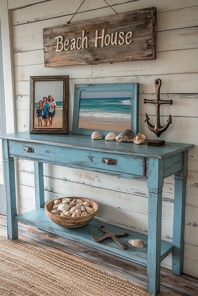 a blue table with pictures and an anchor on it next to a sign that says beach house