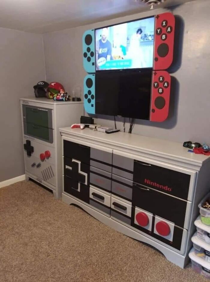 a video game room with nintendo wii controllers on the wall and an entertainment center in the corner